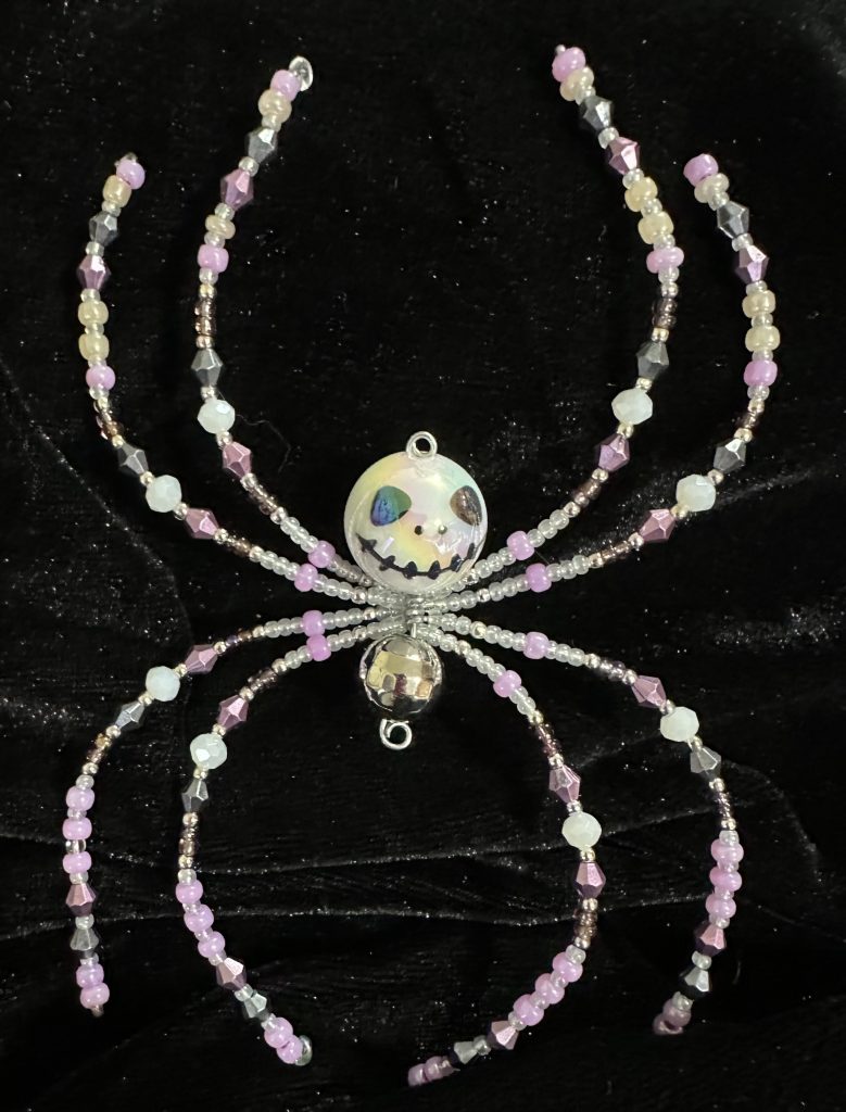 Halloween themed beaded spider with a skeleton face body