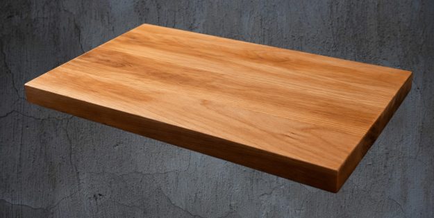 Wooden cutting board on a rustic surface with additional views and dimensions displayed.